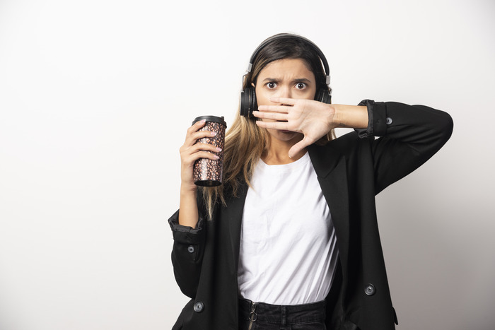 public/articles/2025/october/businesswoman-with-cup-headphones (1).jpg